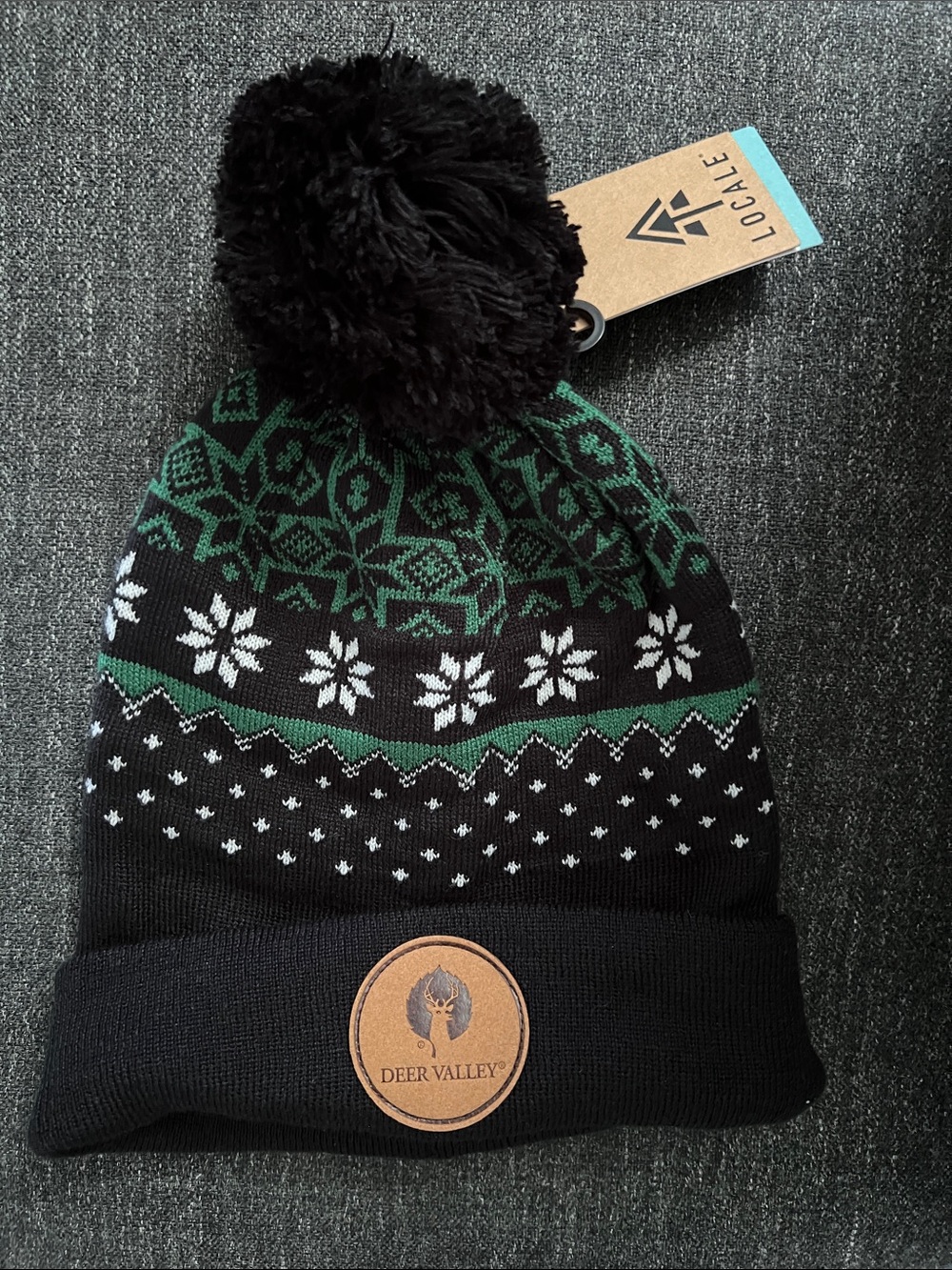 NWT Deer Valley Pom Beanie in Black & Green Locale